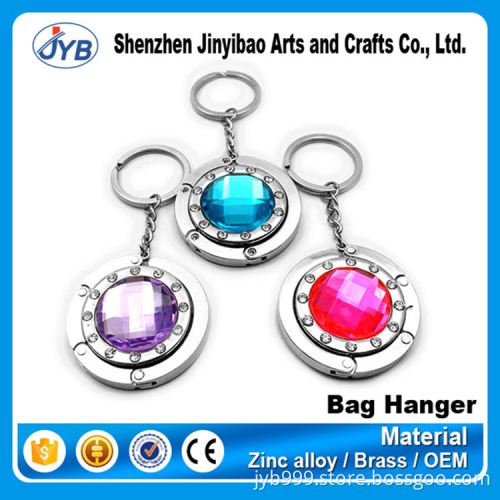 beautiful design metal round shape foldable bag hanger on table top